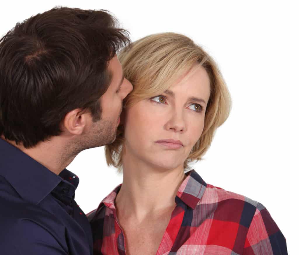 man trying to kiss uninterested wife